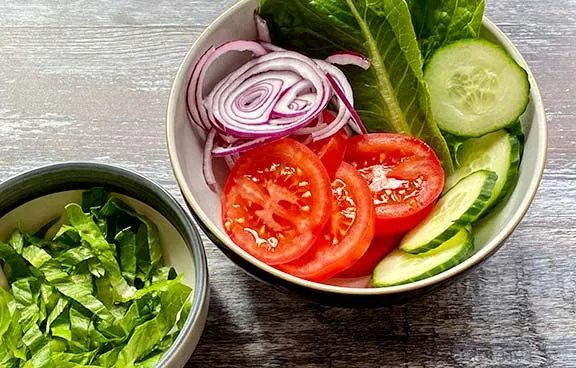 Salad for burgers. Tomato, lettuce, cucumber and onion.