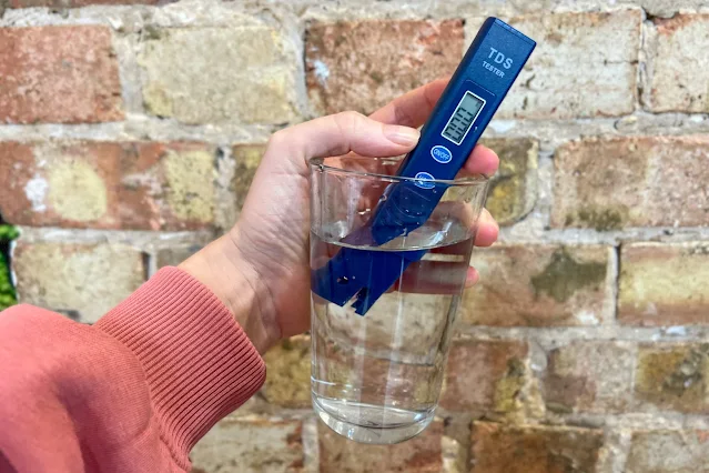 a TDS meter in water with a reading of 000