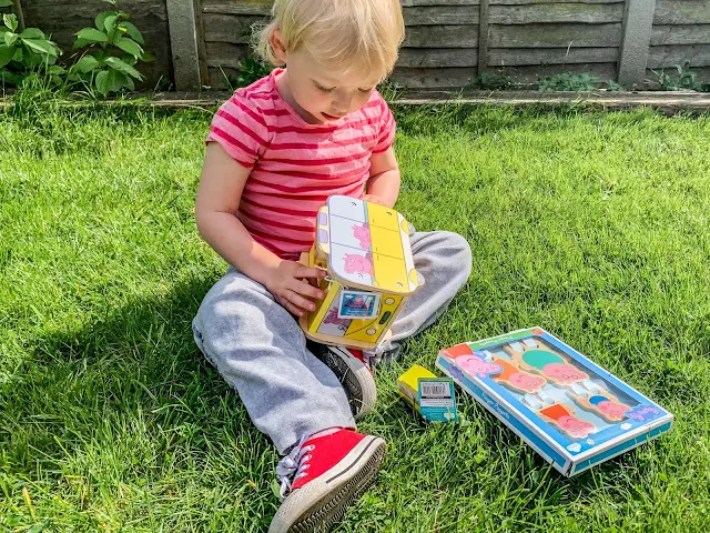 Toddler opening Wooden Peppa Pig Toys from Milly & Flynn