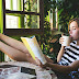 Beautiful girl drinking coffee while reading