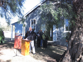 Peter Garrett speaks to those present in front of the Myall Creek Country Womens Association hall