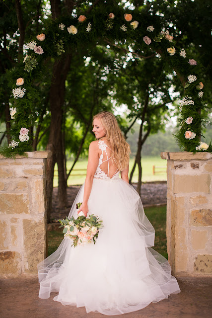 Something old, something new, something borrowed, something blue.  Sarah looked like she could have stepped right out of a Vogue Bridal magazine as she floated down the stairs in her beautiful wedding gown: a fitted, sleeveless, delicate lace bodice above a floor-length skirt, comprised of yards and yards of whimsical, white organza.  Tanner looked dapper in his royal blue suit, paisley tie, white rose boutonniere, and fancy, wood-grained leather shoes.  The bridesmaids and maid-of-honor wore individually designed, pale-pink, floor-length gowns and carried small bouquets similar to the bride’s pastel bouquet of beautiful, blush and ivory roses and ranunculus.      The SpringsEvent Venue in Edmond, OK, with its rustic and elegant accommodations, was the perfect setting For Sarah and Tanner’s intimate wedding and reception.  The morning began with First Looks for both the bride’s father, and then Tanner.  The clouds threatened rain throughout the morning—and almost drenched the bride and her maids during the picture-taking for the wedding party—but miraculously cleared up for the outdoor wedding nuptials.  The wedding couple were blessed to have so many people who traveled from throughout the country to celebrate their special day.   Sarah and Tanner agreed that their two favorite parts of the day were “getting to see each other during the first look, and then the actual wedding when we said our vows.”  Sarah said that during the first look, “we were able to spend those precious moments focusing on each other without all the hustle and bustle around us.”  After months of preparation and planning, she said, “the vows were also our favorite because we were finally getting married!”  Sarah’s suggestions to future brides, now that she has experienced her own wedding:  "Each and every moment is special:  getting ready, the first looks, walking down the aisle, the vows, the cake cutting, the dancing…take a moment or two to just slow down and take it all in…you’ll be glad you did!"  It was my pleasure to capture these beautiful memories for Sarah, Tanner and their families that will last forever.  For more information about my Wedding Packages, please visit my Weddings page on my website, www.michellevalantinephotography.com. 