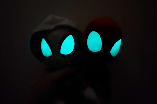 The plush in the dark with pretty much only their glow in the dark eyes visible