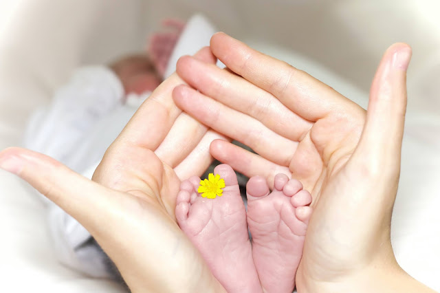 baby feet:Photo by Manuel Schinner on Unsplash