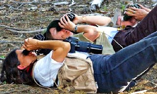 Birders on their backs watching birds