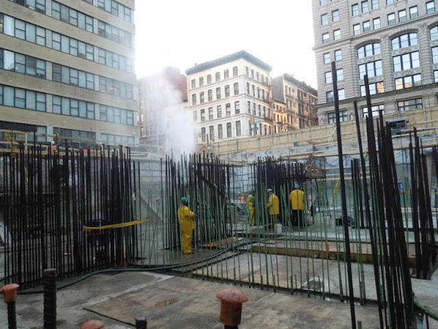 Picture of workers steam watering the steel