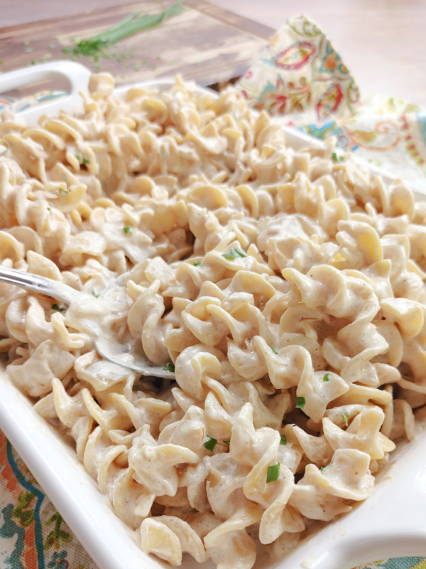 This photo shows a white casserole dish with Polish Noodles ready to serve. 