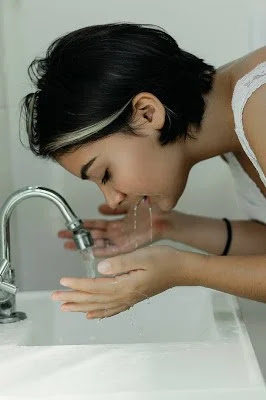 washing her face for makeup