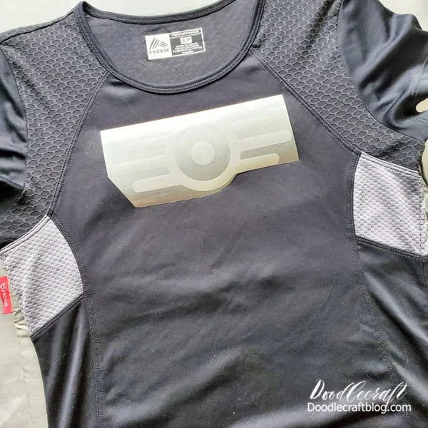 Step 4: Iron-On  Cut the logos apart and place the athletic shirt on the Cricut EasyPress Mat.   Heat up the shirt with the Cricut EasyPress for about 10 seconds.   Then place the front logo on the front of the shirt.   I center my logo 2 inches down from the neck hem.