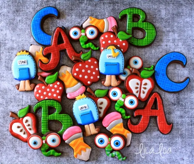 Brightly decorated back to school sugar cookies - backpacks cookies, bookworm cookies,  pencil cookies, apple cookies and letter cookies