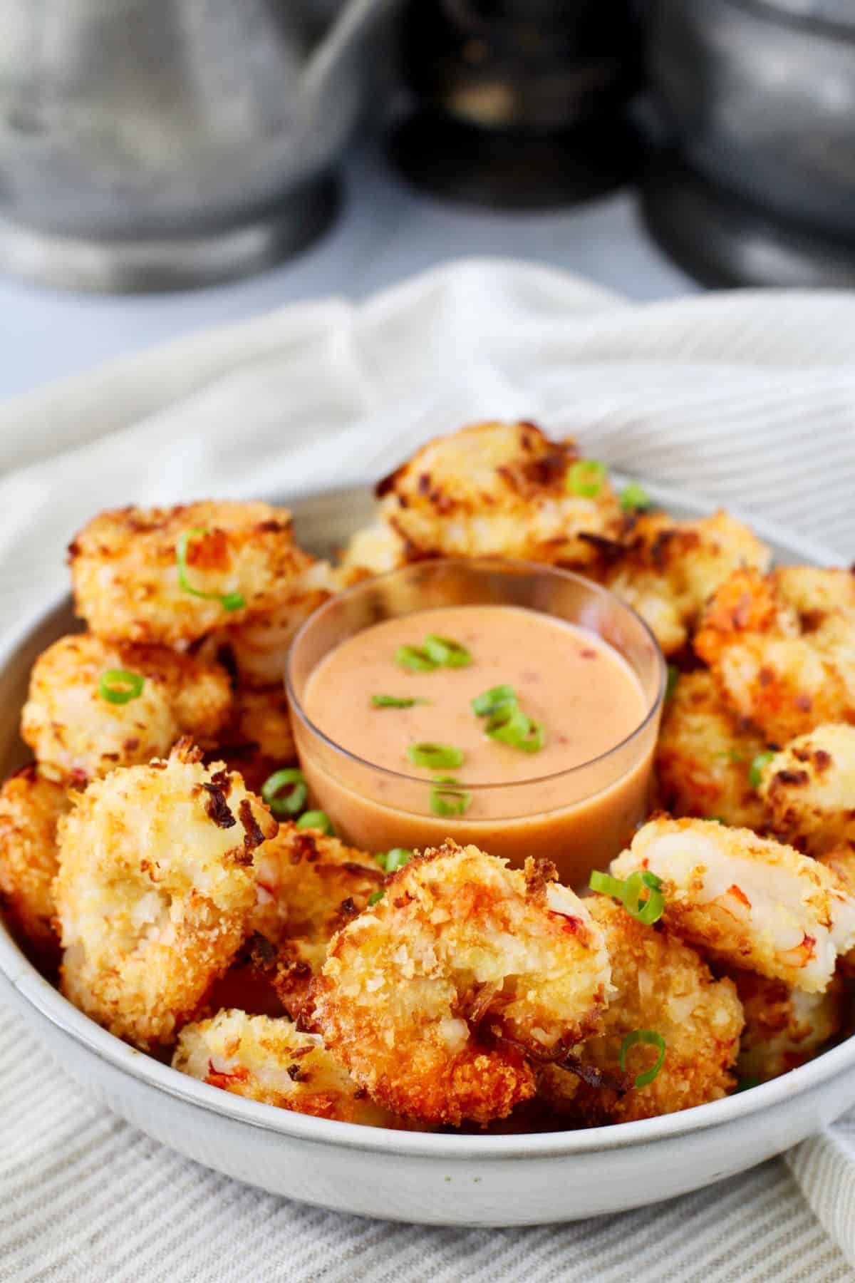 Air Fryer Crispy Coconut Shrimp in a serving bowl with dipping sauce.