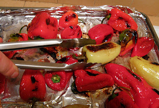 Hand with Tongs Turning Peppers