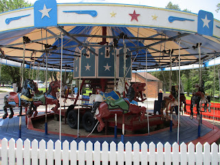 Carousel or Merry-Go-Round at High Point City Lake Park High Point City Lake Park - wood carving at the edge of the parking lot © Katrena