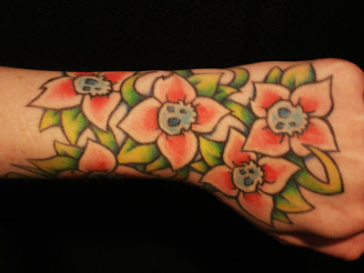 tattoos of skulls and flowers. tattoos of skulls and flowers.