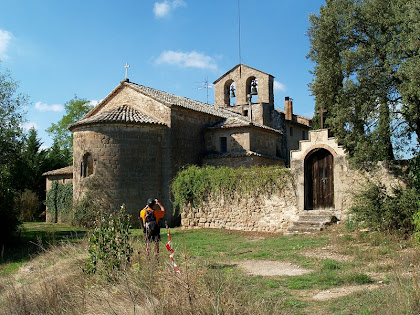 Les façanes de llevant i nord de Sant Pau de Casserres amb el petit cementiri al seu costat