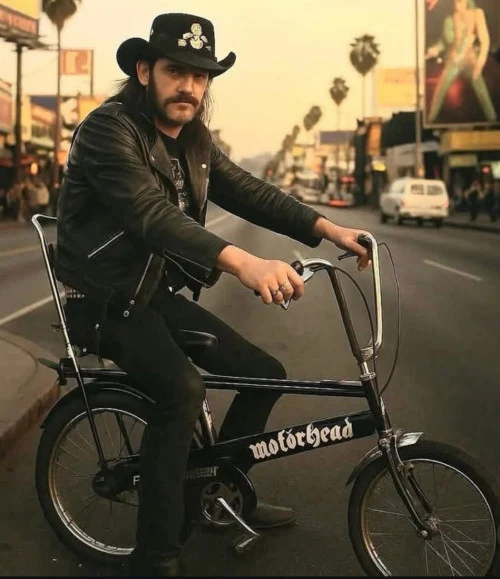 Mercenary Garage Custom Motorcycle Workshop Lemmy Kilminster of Motorhead on a Custom Matte Black Raleigh Chopper Bicycle AI Photochop