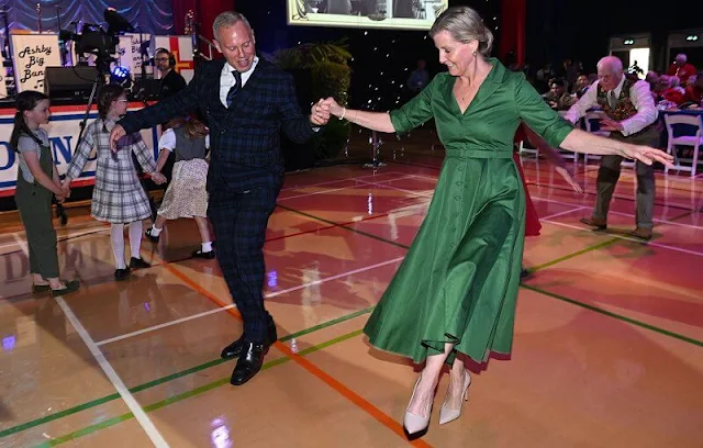 Countess of Wessex wore a white indiana jacket by Altuzarra, and a Kasia floral print dress by Erdem, a green satin silk shirt midi dress