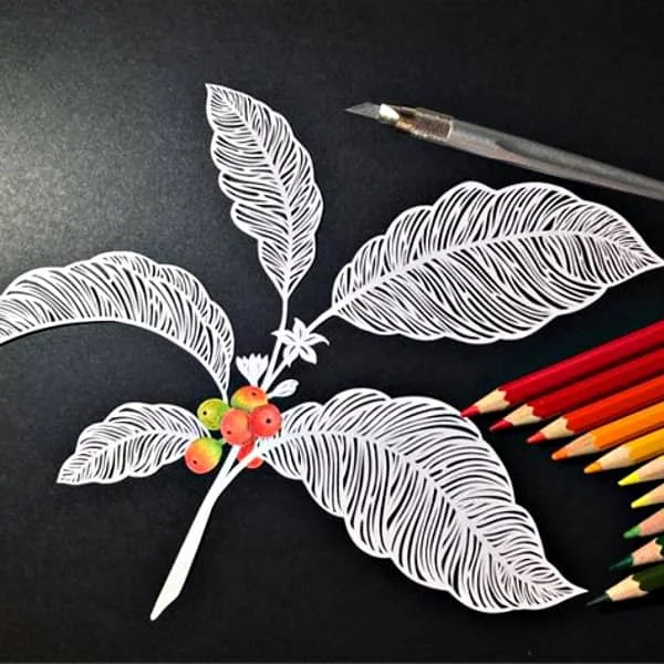 paper cutting of a coffee plant with cherries and flowers