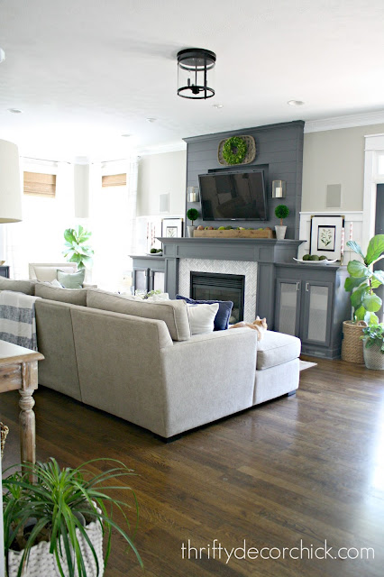 Sectional and dark gray fireplace