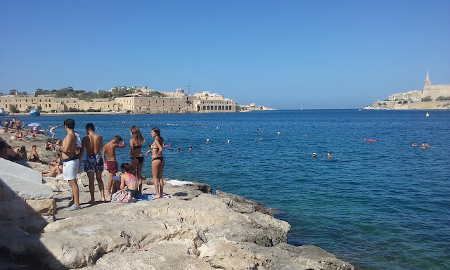 people on a beach in Ta' Xbiex