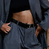 Person in gray pants and black leather belt