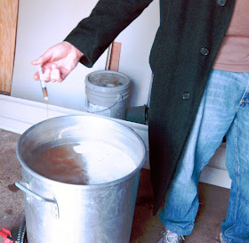 Adding the first of two HopShots to the boil.