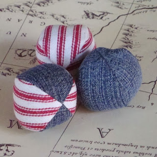 Hacky sacks made out of solid-blue and red-and-white striped denim