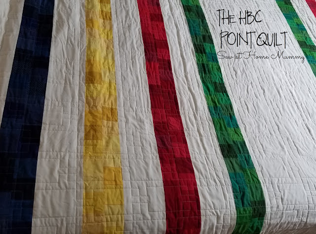 An easy DiY Hudson's Bay Co HBC Point Blanket Quilt featuring traditional pattern front with pixelated stripes, blue single color point blanket backing (making the quilt fully reversible), all pieced with Aurifil thread! by Erin D. of Sew at Home Mummy