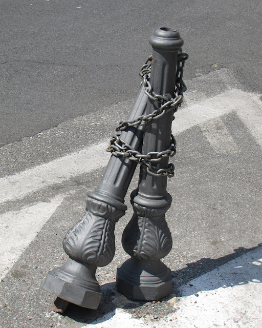 Chained bollards in love, largo Santa Susanna, Rome