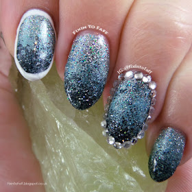 Loose glitter gradient nail art outlined with rhinestones and polish.