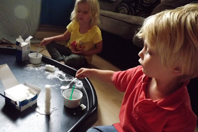 Messy construction play with sugar cubes and water icing