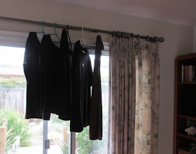 laundry hanging to dry on curtain rod