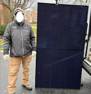 REC 405AA solar panel looks completely black and can generate 405 watt per hour, see the size based on a person standing next to it.