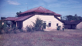 Yellow Bungalow with red tin roof in Suburb of Satara India