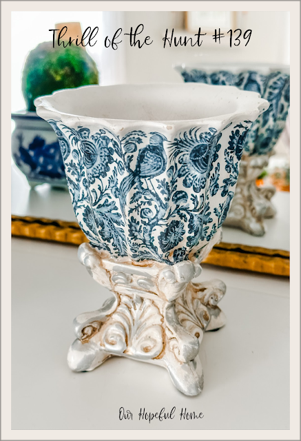 blue and white urn on silver pedestal