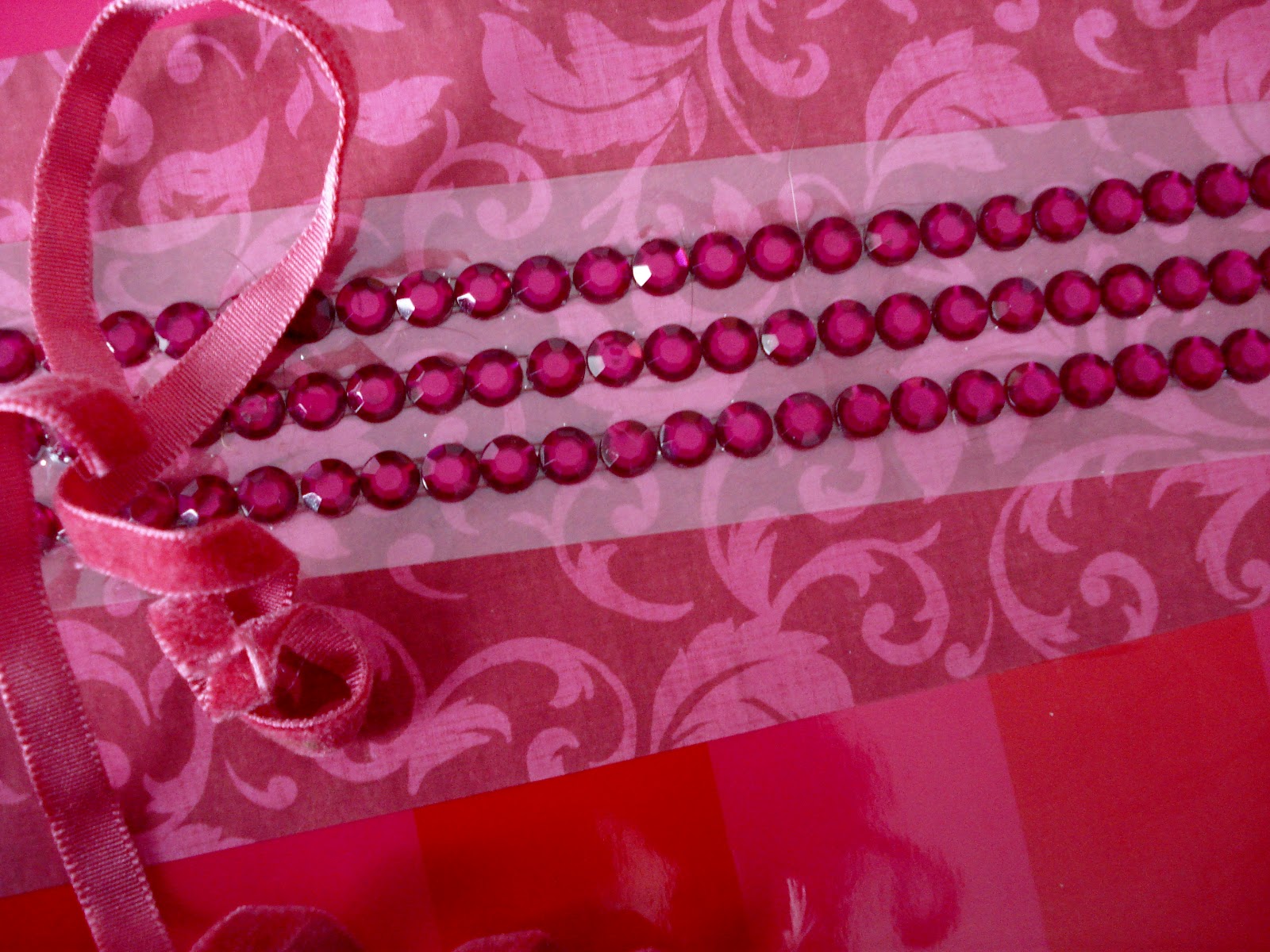 strip of hot pink rhinestone stickers, and rose colored velvet ribbon ...