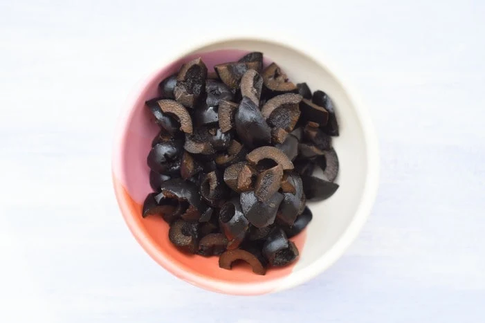 halved black olives in a bowl.
