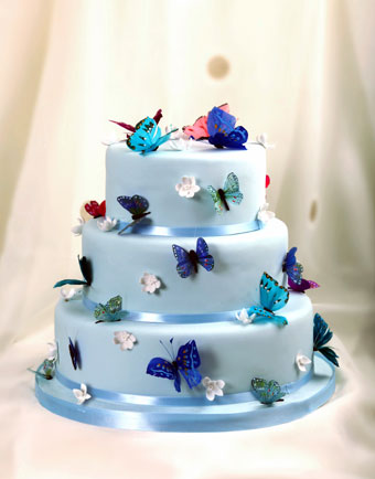 This lovely three tier bluish lavender wedding cake has edible waferpaper 