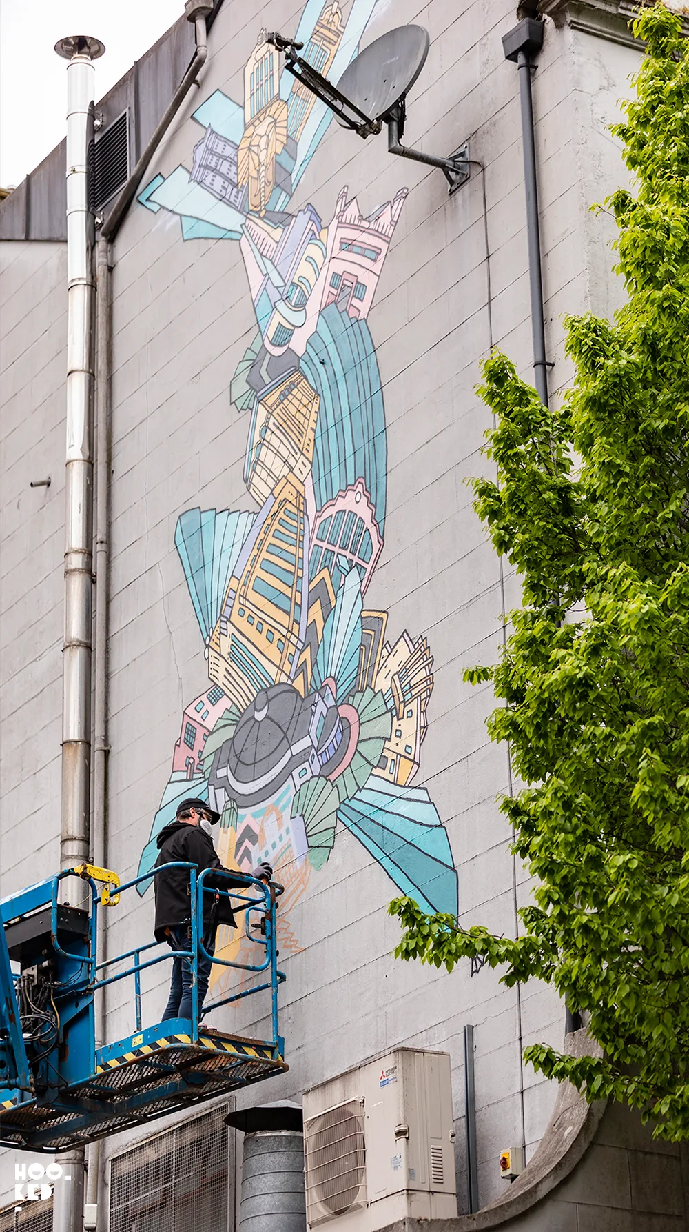 Artist Andy Council at work on a mural in Belfast, Ireland