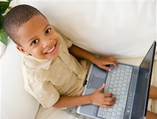 Smiling boy with a laptop