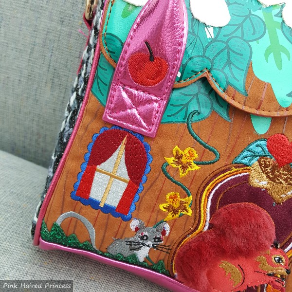 mouse and apple embroidery on front of cabin shaped handbag