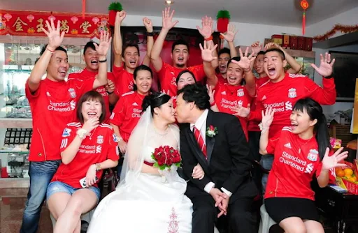 The happy newlywed Liverpool fans take pictures with fellow Kopites