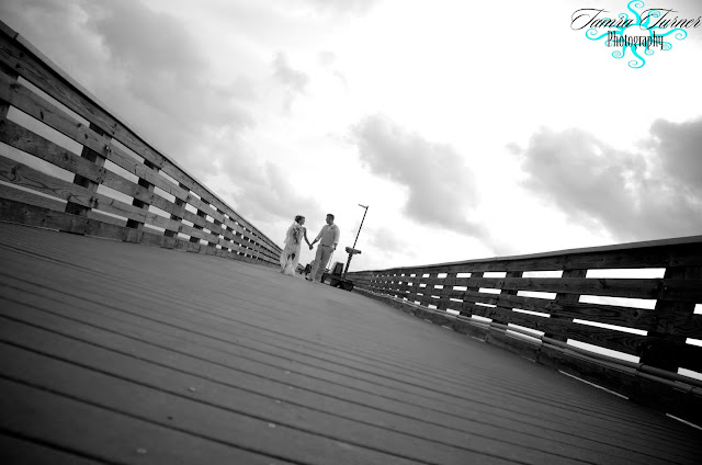 walking hand in hand on the fishing pier at St. Andrew's in Panama City Beach