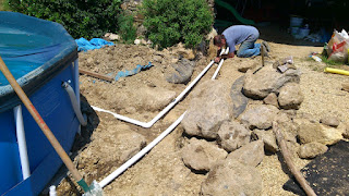 Geoff hard at work cutting out and fixing yet another leaking pipe joint