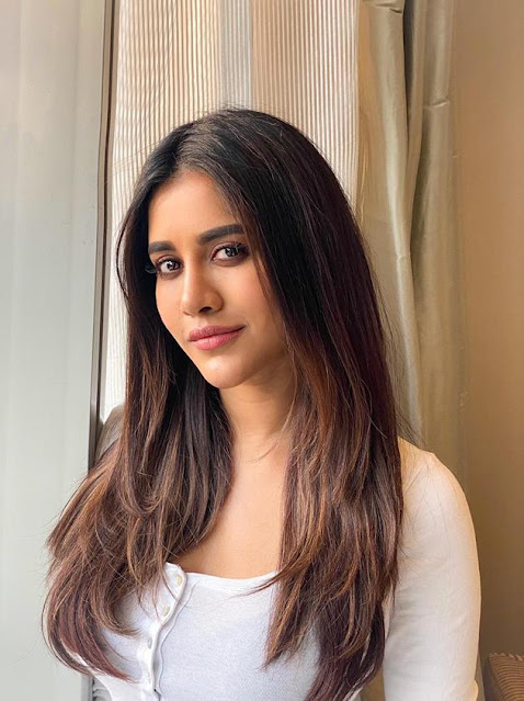 Nabha Natesh looks adorable in a cute pose, dressed in a white outfit