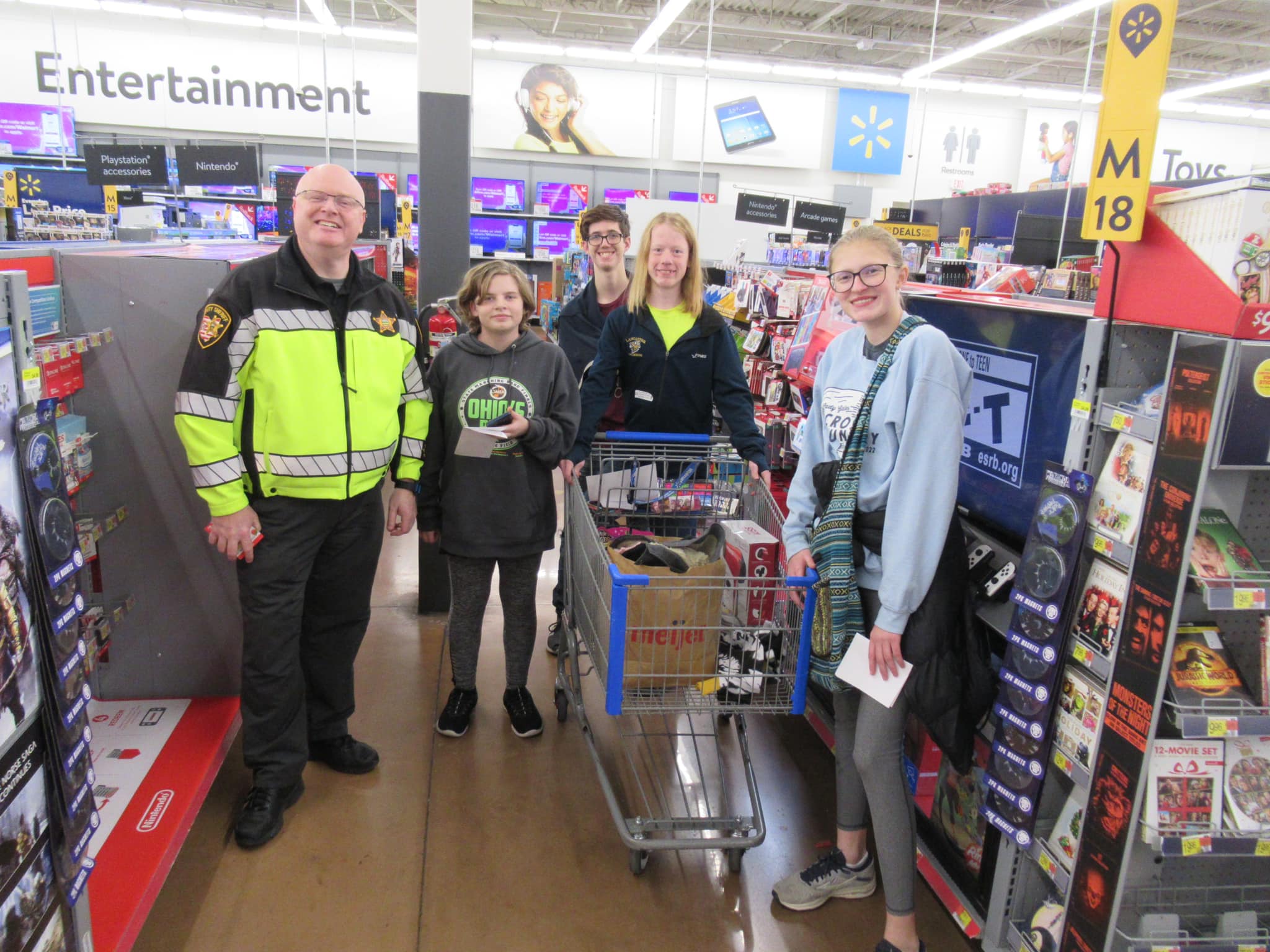 cop, sheriff and high school students shopping