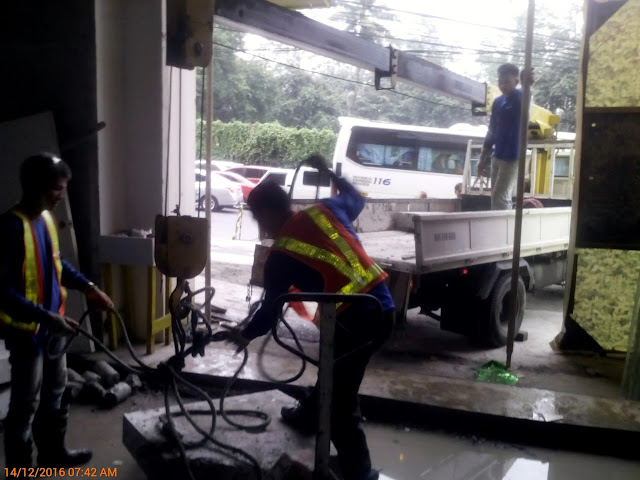 Boom truck lifting the cut concrete slab