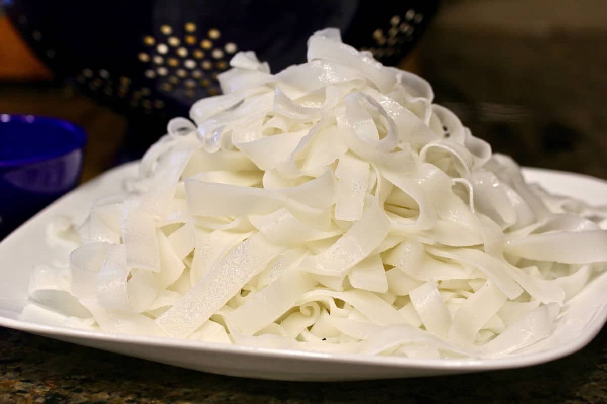 Rice noodles piled on a plate.