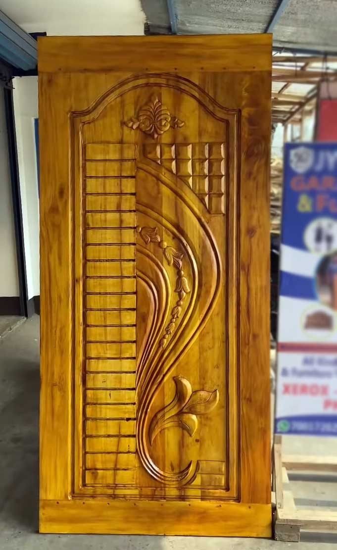 A beautifully crafted door made of Jackfruit wood, highlighting the wood's warm golden-brown tones and unique grain pattern.