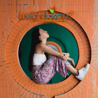 Woman seated inside a round wall opening